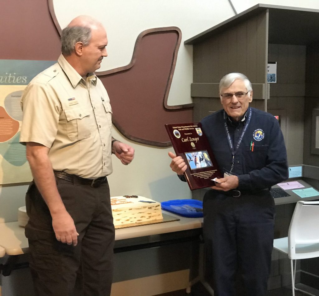 Carl Zenger receives commemorative plaque from INWR manager Tom Roster. The plaque recognizes Carl for the 35,000 hours of service he has volunteered at the refuge.