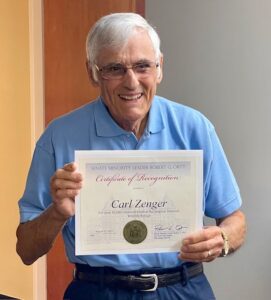 Carl Zenger displays his state Senate Commendation Certificate. 